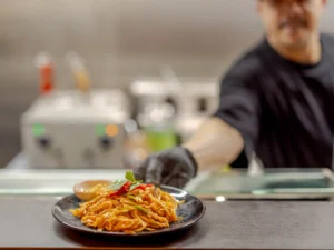 Thai Chef Serving Fresh Pad Thai at Siam Bowl Amsterdam